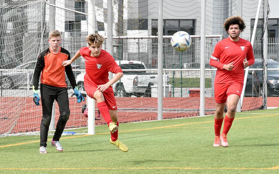 Kaiserslautern's Nikolai Engeman, center left, clears the ball while fellow Raiders, from left, William Herrman and Jackson Armstrong watch during Saturday afternoon's match against Vilseck at Kaiserslautern High School in Kaiserslautern, Germany.