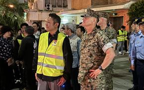 Mayor Daisuke Hanashiro, left, and Maj. Gen. Brian Wolford, commander of Marine Corps Installations Pacific, take part in a joint patrol of Gate 2 Street in Okinawa city, Okinawa, April 18, 2025. 