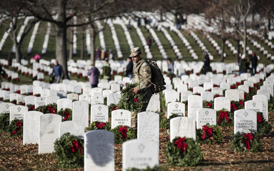 Volunteers participate in the 32nd Wreaths Across America Day In Section 64 of Arlington National Cemetery, Arlington, Va., Dec. 16, 2023.