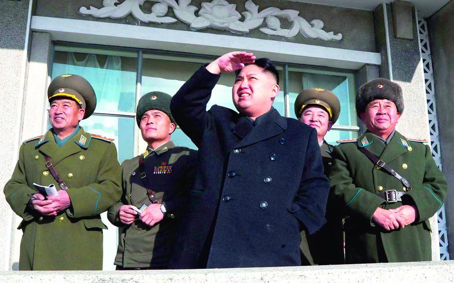 North Korean leader Kim Jong Un stands with officials in this undated photo from the Korean Central News Agency.