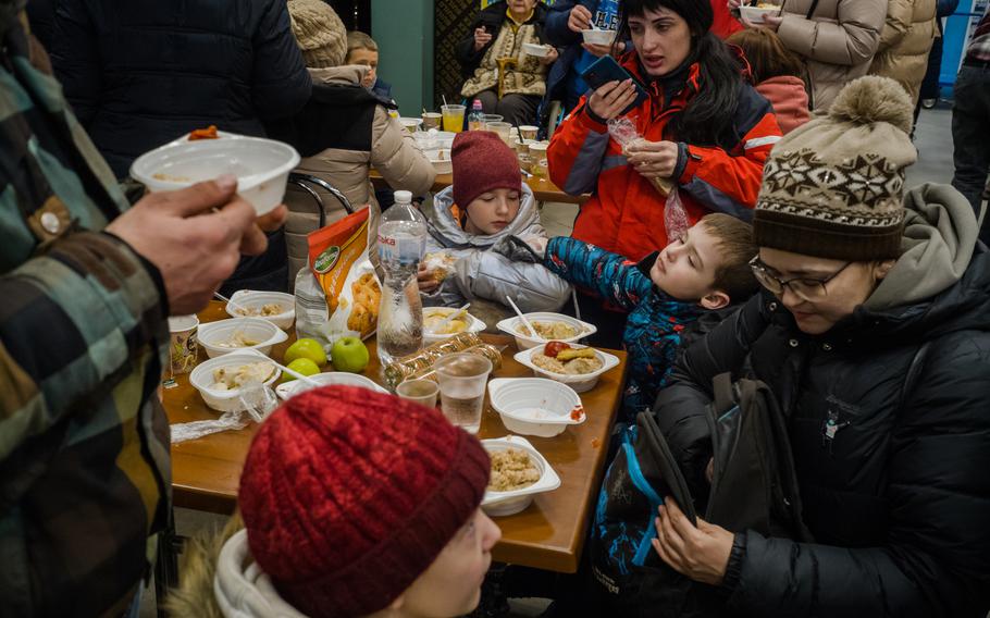 People fleeing from Mariupol, Ukraine, arrive to the registration center in Zaporizhzhia, Ukraine, on Friday. Nine members of Aleksei Vlasov and Alesya Vlasova's family came.