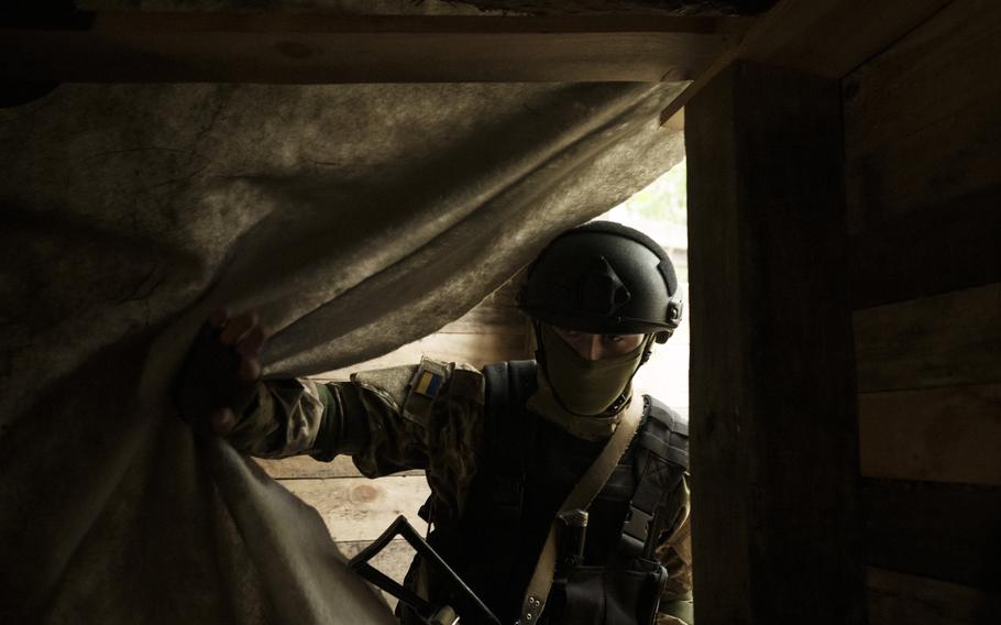 A Ukrainian National Guard soldier enters an underground shelter at a position near Kharkiv, Ukraine, Monday, May 9, 2022.