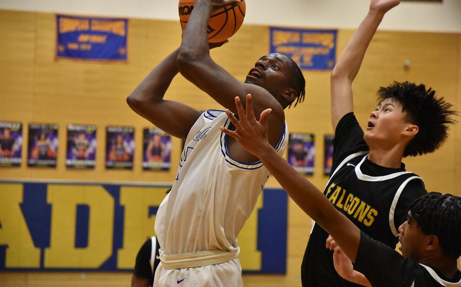 Rota’s Brian Leiba tries to score off an offensive rebound while being challenged by Bahrain’s Jacob Courts on Wednesday, Feb. 14, 2024, during the opening day of the DODEA European Division II Basketball Championships in Wiesbaden, Germany.