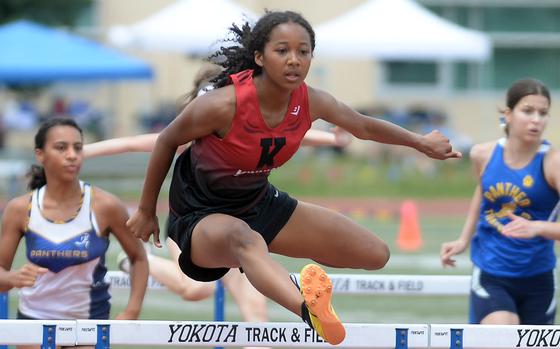 Kinnick's Nina Gaudin navigates the jump en route to victory in the 100 hurdles.