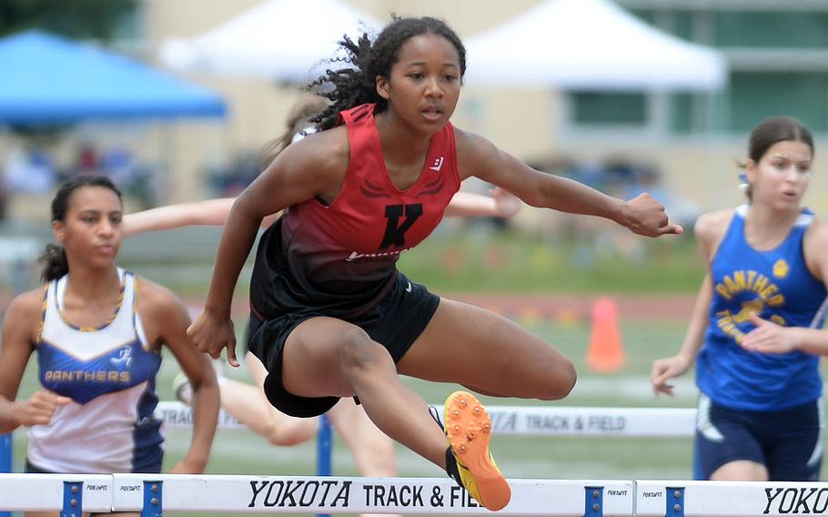 Kinnick's Nina Gaudin navigates the jump en route to victory in the 100 hurdles.