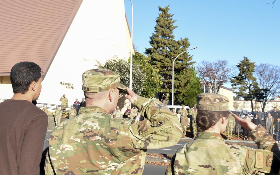 Airmen and other community members pay their respects as Osprey crew members' remains depart Yokota Air Base, Japan, Wednesday, Dec. 13, 2023.