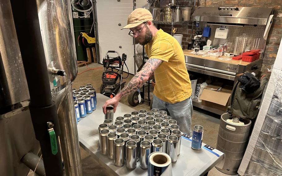 Chris Bump, the brewer at Fox City, preparing cans of Revival lager. 