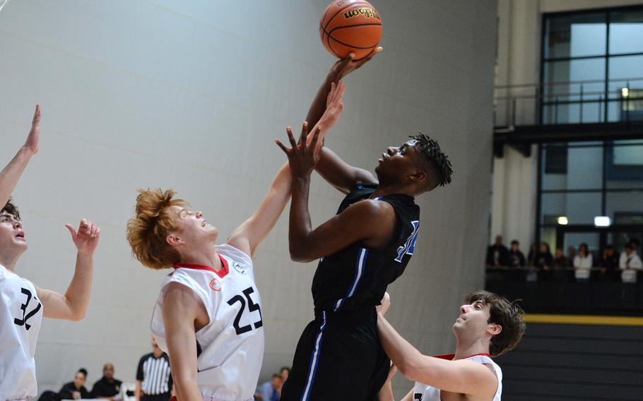 Rota’s Brian Leiba shoots over AOSR’s Anthony DiMatteo in a Division II semifinal at the DODEA-Europe basketball championships in Ramstein, Germany, Feb. 17, 2023. Rota won 59-51 to advance to the championship game against Naples.