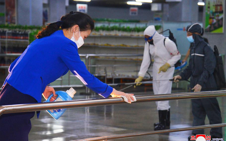 North Korean employees disinfect a facility at an underground store in Pyongyang, North Korea. Independent journalists were not given access to cover the event depicted in this image distributed by the North Korean government.