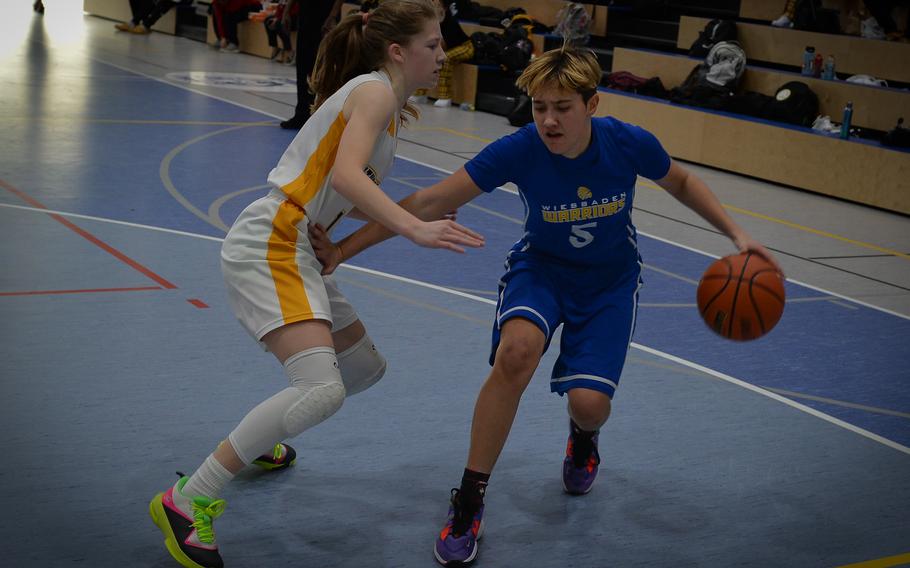 Wiesbaden's McKinley Viers pushes for the basket against Stuttgart defender Haley Wells at the DODEA European Division I girls basketball championships Feb. 16, 2023, at Ramstein Air Base, Germany. Wiesbaden beat Stuttgart 50-15.