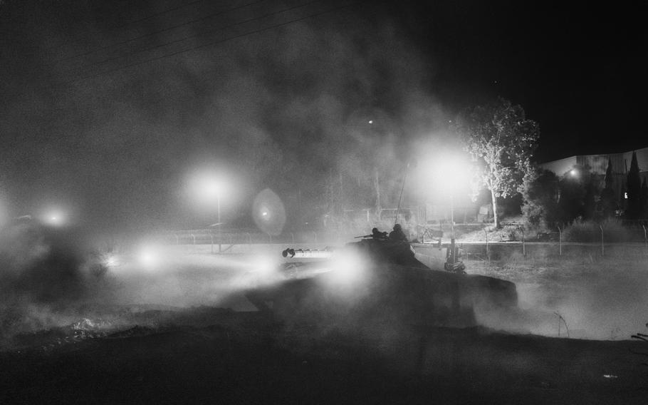 A tank maneuvers on a dusty road near Kibbutz Beeri on Oct. 11, 2023. 
