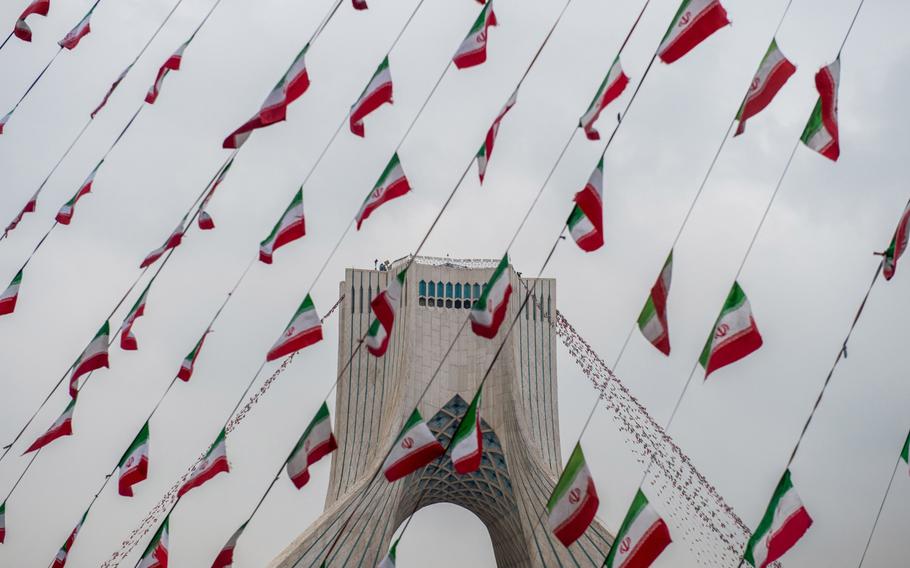 Iranian national flag bunting hangs in front of the Azadi Tower in February 2019.