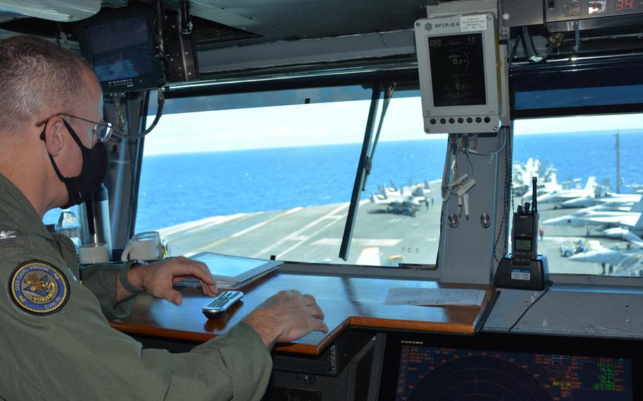 Capt. P. Scott Miller, commander of the aircraft carrier USS Carl Vinson, surveys aircraft on the ship’s bow as it steams north of Oahu, Hawaii, on Aug. 14, 2021.