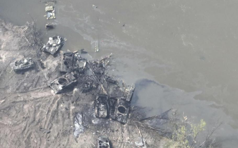 Dozens of destroyed or damaged Russian armored vehicles on both banks of Siverskyi Donets River are seen on Thursday, May 12, 2022, after their pontoon bridges were blown up in eastern Ukraine. 