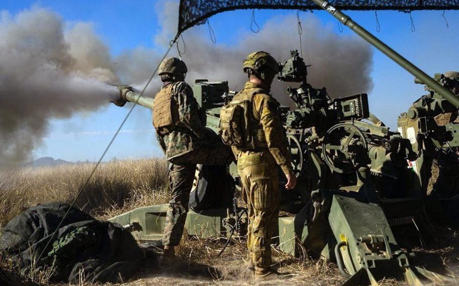 U.S. Marines and Australian soldiers fire an M777 howitzer during the Talisman Sabre exercise at Shoalwater Bay Training Area in Queensland, Australia, July 17, 2021. 