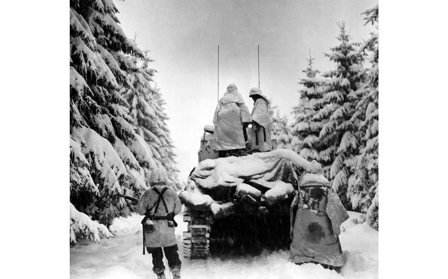 Battle of the Bulge tanks and infantrymen of the U.S. Army’s Company G, 740th Tank Battalion, 504th Regiment, 82nd Airborne Division, push through the snow toward their objective near Herresbach, Belgium, Jan. 28, 1945. 