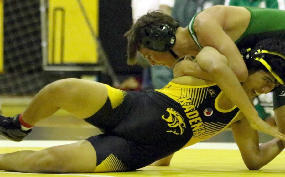 Kadena's Jayden Guevara and Kubasaki's Nathan Voekel do battle at 141 pounds during Wednesday's Okinawa wrestling dual meet. Guevara won by 14-8 decision and the Panthers won the meet 42-15.