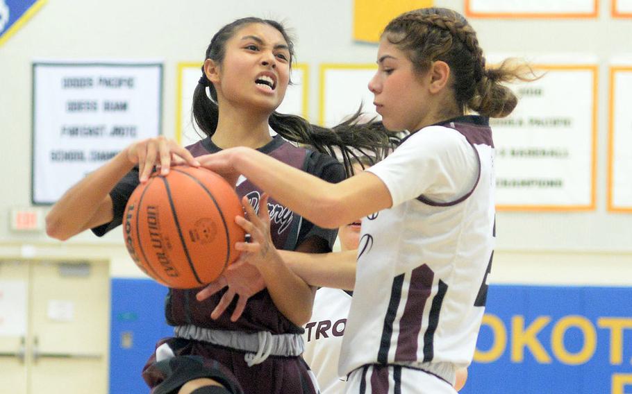 Perry's Aiana Bulan and Zama's Isabella Rivera Munoz tangle for the ball. The Trojans rallied for a 26-18 win.