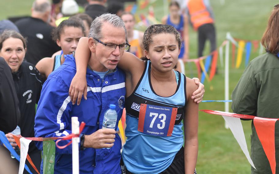 Hohenfels’ coach helps his runner walk away from the course.