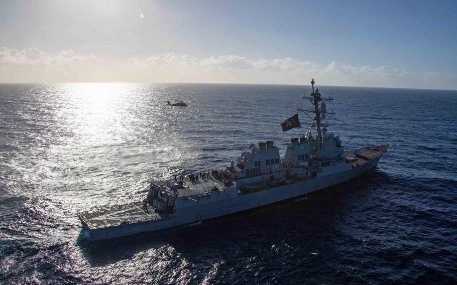 An MH-60S Sea Hawk flies above the destroyer USS Bulkeley in the Mediterranean Sea on Dec. 24, 2023. U.S. Navy sailors helped save the lives of 30 people stranded on a boat adrift for days in the eastern Mediterranean on July 16, 2024. Another passenger died following attempts at resuscitation. 