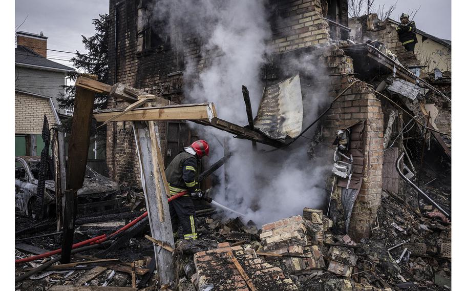 Firemen attend to a residential building after it was destroyed by a falling missile in a suburb of Kyiv, Ukraine, on Thursday, Dec. 29, 2022.