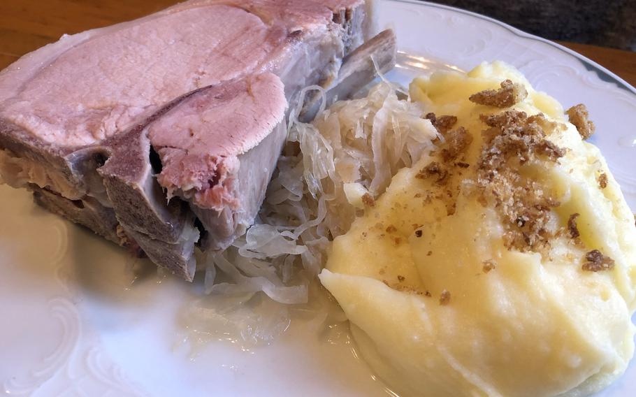 Frankfurter Rippchen, a cured, cooked pork chop, as served at Zum Gemalten Haus in Frankfurt, Germany, with sauerkraut and mashed potatoes. You can also order it grilled at the popular wine tavern in the Sachsenhausen district.