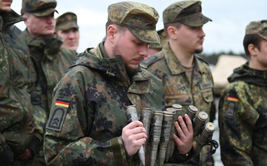 German army Sgt. Bjoern Kaiser looks at ammunition from a Bradley Fighting Vehicle during an exchange with U.S. soldiers in Grafenwoehr, Germany on Feb. 22, 2024. There are four exchanges per year between German and American soldiers.