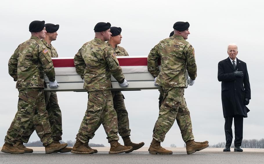 Joe Biden watches as an Army carry team moves the transfer case containing the remains of U.S. Army Sgt. Kennedy Ladon Sanders at Dover Air Force Base, Del., on Feb. 2, 2024.