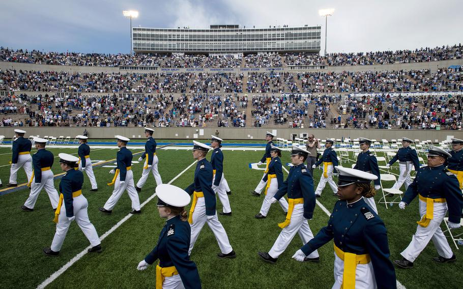 Air Force Academy cadets make their way to their seats as family and friends cheer from the stands during the United States Air Force Academy’s Class of 2021 graduation ceremony in Colorado Springs, Colo., on May 26, 2021.