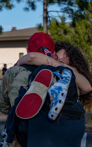 A U.S. Air Force airman assigned to the 823rd Rapid Engineer Deployable Heavy Operational Repair Squadron Engineer reunites with his family at Hurlburt Field, Fla., Sunday, April 14, 2024. 