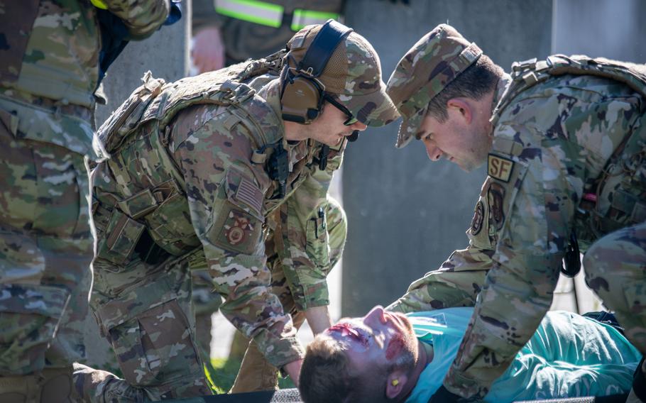 Airmen place an injured role-play victim on a gurney from aeromedical evacuation via helicopter during a PATRIOT 24 search and rescue exercise, Camp Shelby, Miss., Monday, Feb. 19, 2024.
