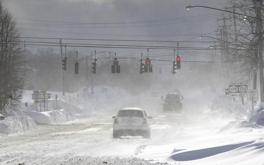 Cars drive through blowing, drifting snow on McKinley Parkway in Hamburg in Erie County, N.Y., Sunday, Nov. 20, 2022. 