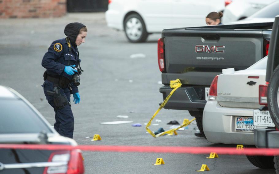 El Paso Police Department crime investigators gather evidence Monday morning at the site of a homicide where a Fort Bliss soldier was killed and three other men were wounded Sunday night in the Five Points area.