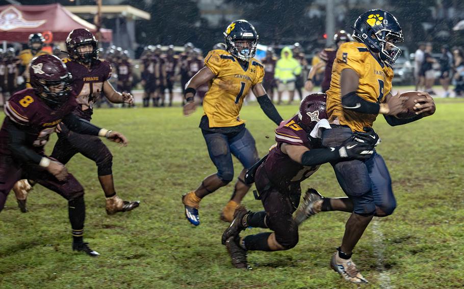 Guam High's Dante Parker drags a Father Duenas Memorial defender behind him.
