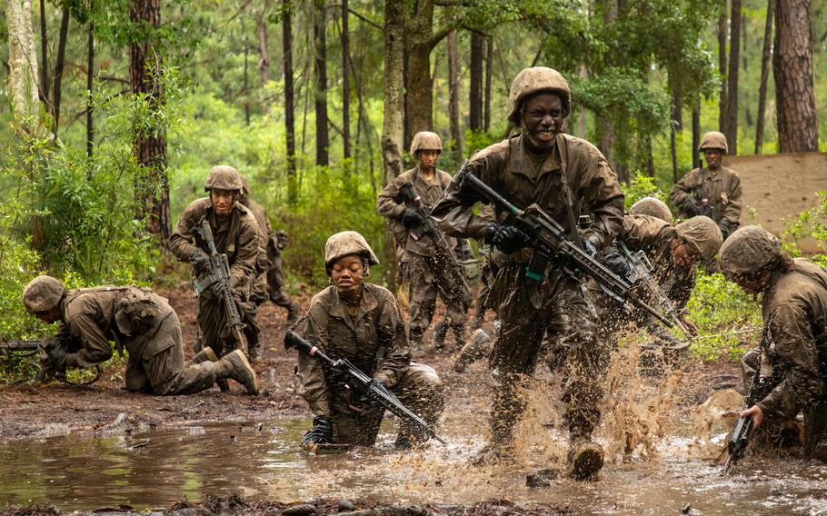 Male and female recruits with 4th Recruit Training Battalion traverse an obstacle course at Marine Corps Recruit Depot Parris Island, S.C., April 28, 2023. The Corps said it will close the unit next month and shift more women to its San Diego recruit depot.