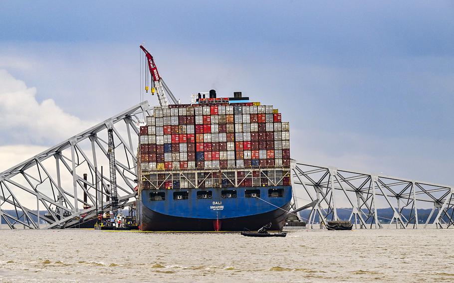 Workers dismantle the collapsed Francis Scott Key Bridge in Baltimore.