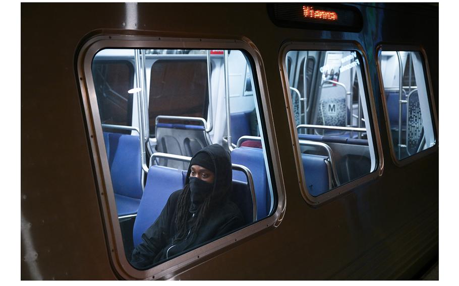 A passenger wears a face covering on a train in Washington, D.C. last week as coronavirus cases increase across the United States. 