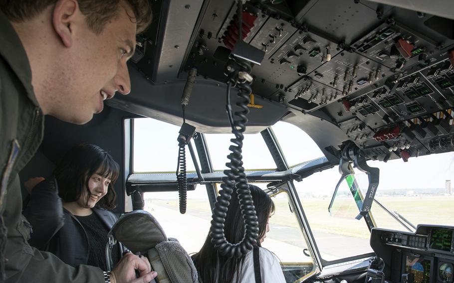 Air Force Capt. Alex Atwood, a pilot for the 36th Airlift Squadron, gives Japanese university students a tour of a C-130J Super Hercules at Yokota Air Base, Japan, April 20, 2023. 