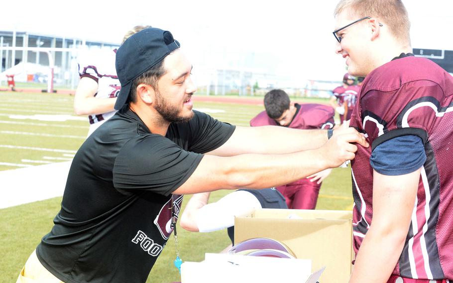 Daniel Burns, left, ascends from offensive coordinator to Matthew C. Perry head coach.