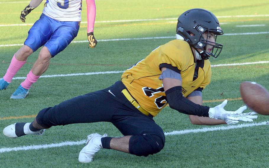 American School In Japan's Stefan Merino hits the deck to haul in a pass just off the turf.