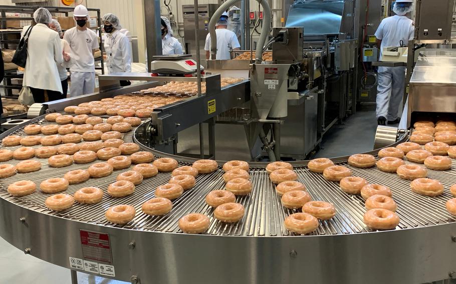 Krispy Kreme doughnuts move off the line at a new Army and Air Force Exchange Service bakery and distribution center at Camp Humphreys, South Korea, Friday, Nov. 19, 2021.