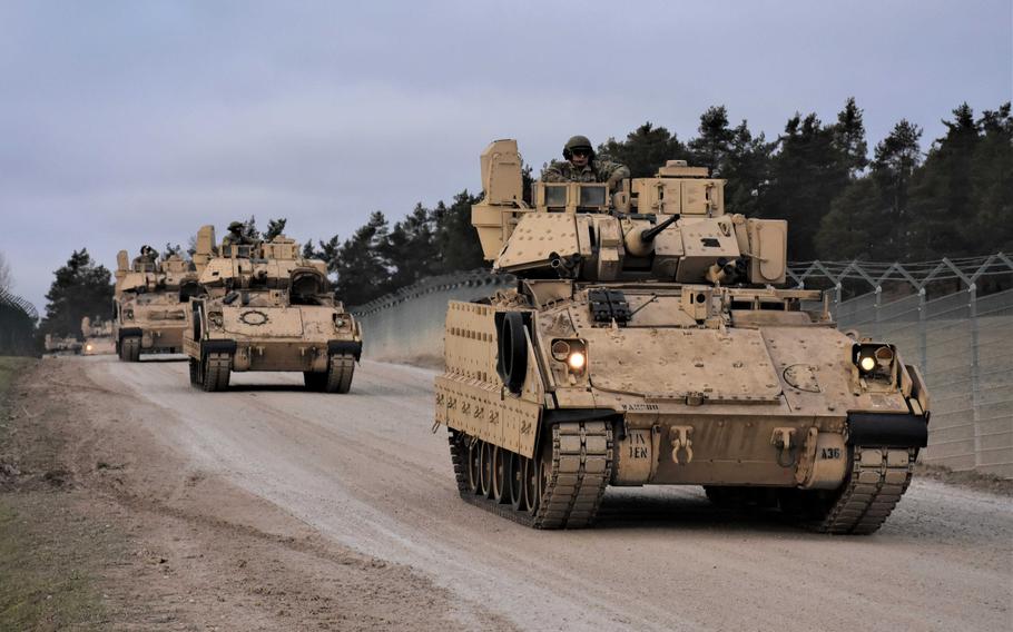 Bradley armored vehicles make their way down a trail at the Joint Multinational Readiness Center in Hohenfels, Germany, in January 2022. The U.S. Army will begin training Ukrainian soldiers at ranges in Germany, where they will learn how to fire and maneuver with Bradleys, military officials said this week.