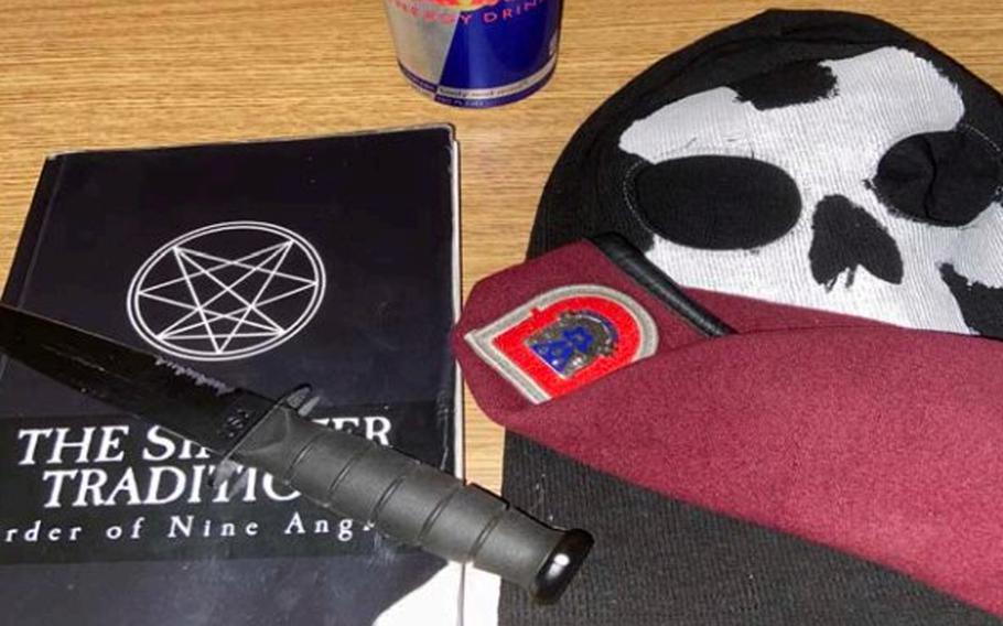 This photo provided by the Justice Department seized from an iCloud account belonging to former Army Pvt. Ethan Melzer displays personal effects, including paraphernalia associated with the extremist group Order of the Nine Angles.