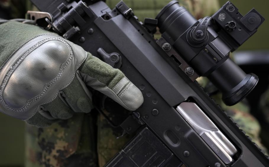 A soldier holds a new M19 rifle made by Serbian armaments company Zastava Arms at an arms fair in Belgrade, Serbia, Tuesday, Oct. 12, 2021.