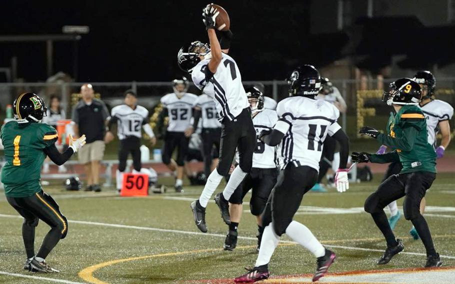 Zama's Vander Perkins leaps high for an interception against Robert D. Edgren. 