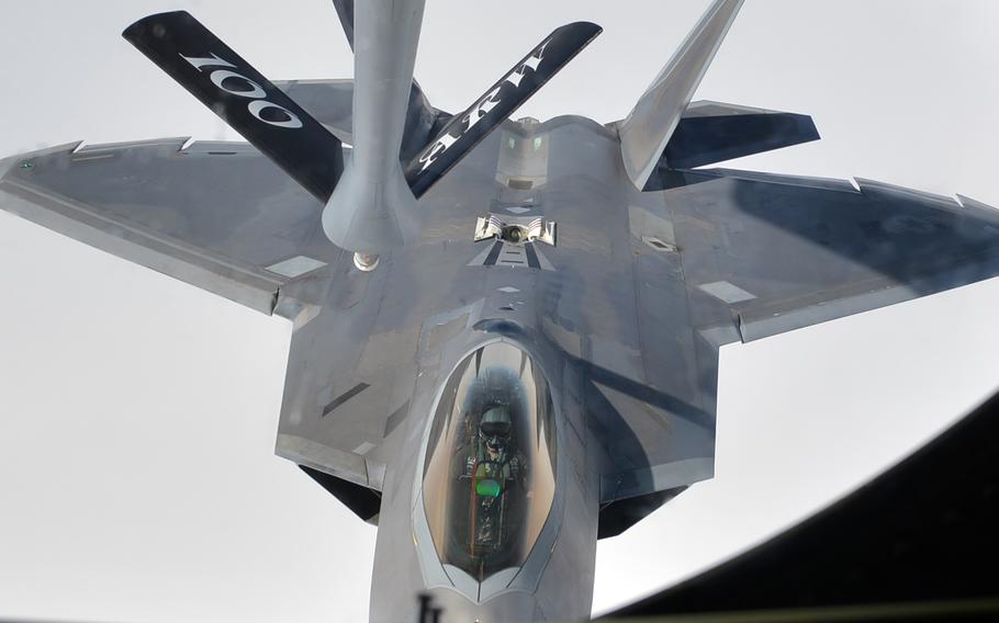 A U.S. Air Force F-22 Raptor pilot comes in for an aerial refueling from a KC-135 Stratotanker during a mission over Europe in 2018. The Air Force plans to provide an improved in-flight bladder relief device to pilots by the spring, the service announced this week.
 