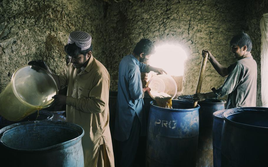 Ephedra power is mixed with chemicals in one of the steps to produce methamphetamine in Farah province, Afghanistan, on March 19.