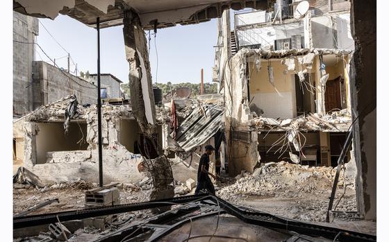 Palestinians walk amid the destruction after the Israeli military operation in Nur Shams, near Tulkarm in the West Bank, on April 23. (MUST CREDIT: Heidi Levine for The Washington Post)
