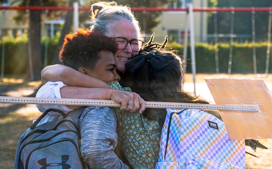 Children from the Grafenwoehr Elementary School are greeted by fourth-grade teacher Nell Dunn, Aug. 22, 2022, in Grafenwoehr, Germany.