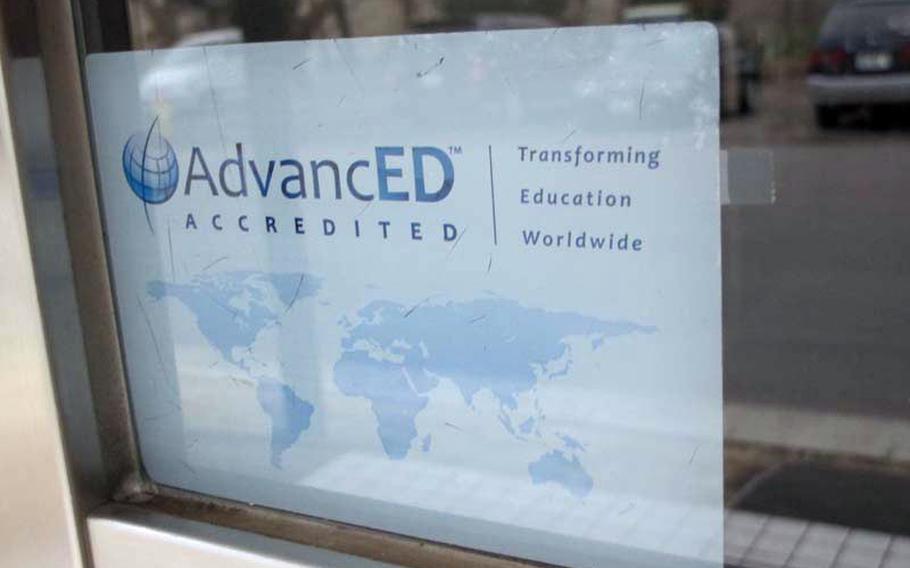 An AdvancED accreditation sticker is displayed on a door leading into Zama American High School in May. The school was placed on accreditation probation earlier this year after evaluators found that the school failed to meet several standards. Loss of accreditation would impact student ability to apply for college, student loans and military service.                         